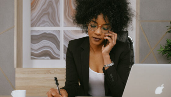 Black Woman In Black Blazer Holding Smartphone