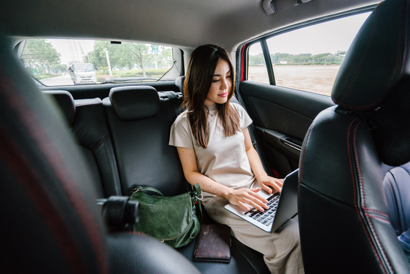 Busy BragWoman Using Laptop Computer Inside Vehicle