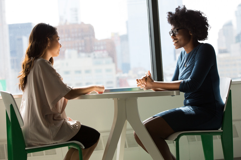 Candor- Two Women Sitting on Chairs Beside Window