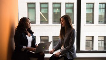 Candor- Woman Holding Laptop Computer Near Window-2