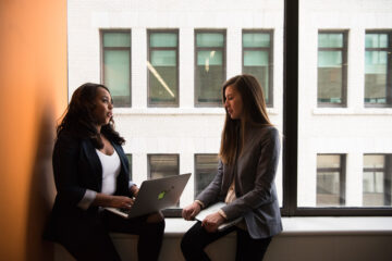 Candor- Woman Holding Laptop Computer Near Window-2