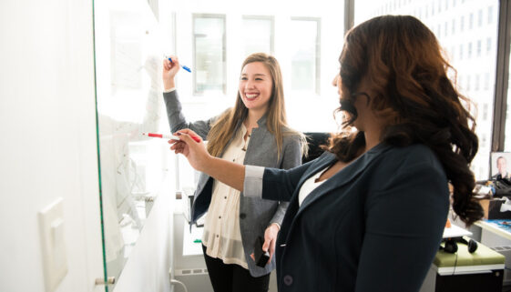 Canva - Two Women in Front of Dry-erase Board