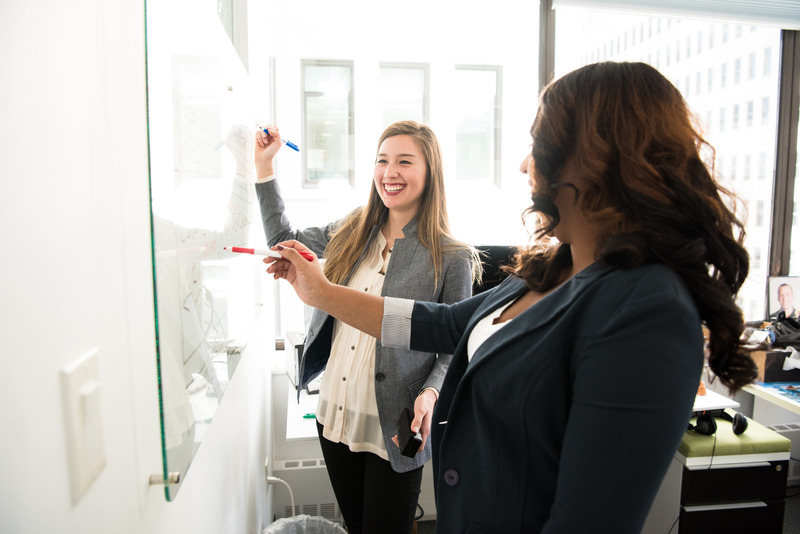 Canva - Two Women in Front of Dry-erase Board