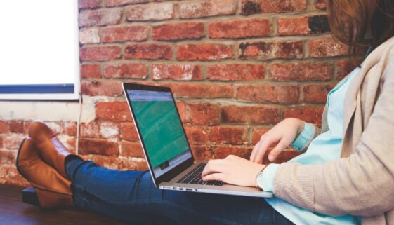 Canva - Woman Sitting on Bench Using Macbook