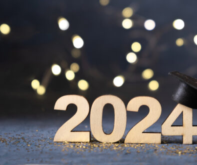 Class of 2024 concept. Number 2024 with graduated cap and bokeh lights banner.