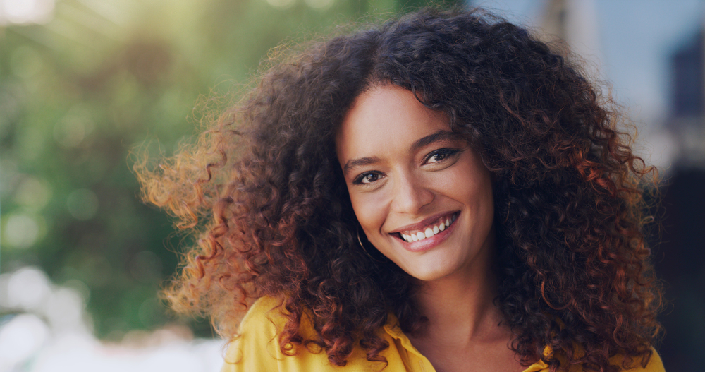 Now is a good time to enjoy life. Cropped shot of a beautiful young woman standing outdoors.