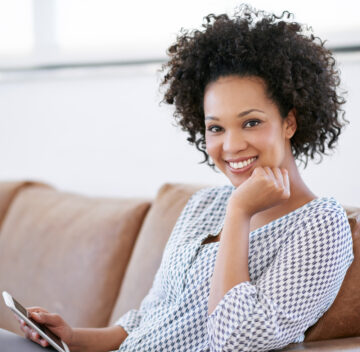 Nowhere more relaxing than home. Portrait of an attractive woman sitting on the sofa with her smartphone. Nowhere more relaxing than home. Portrait of an attractive woman sitting on the sofa with her smartphone.