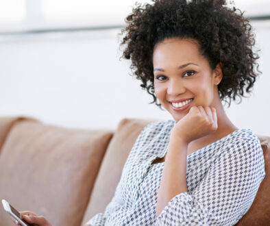Nowhere more relaxing than home. Portrait of an attractive woman sitting on the sofa with her smartphone.