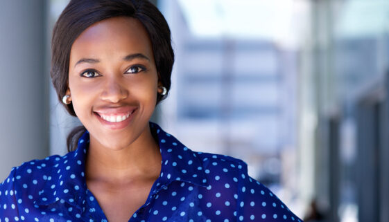 Happy business woman smiling outside office building