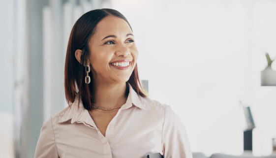 Smile, happy and businesswoman in the office with confident, good and positive attitude. Happiness, ambition and professional female lawyer or attorney from Colombia standing in modern workplace.