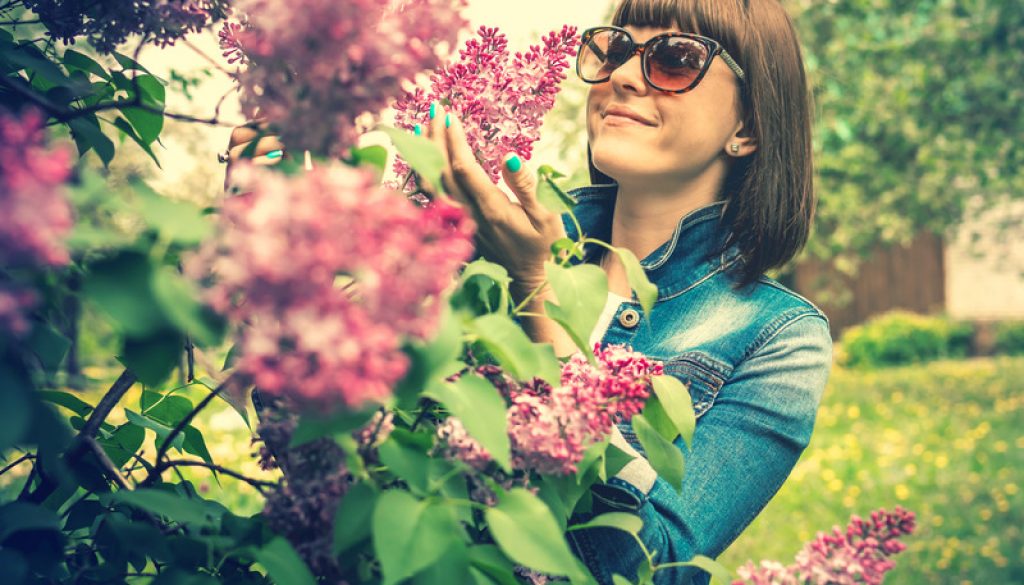 LIlacsCanva - Photo of a woman wearing sunglasses holding lilac flowers