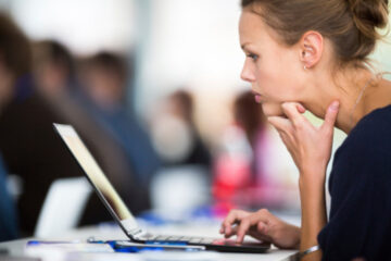 Thoughtful woman laptop