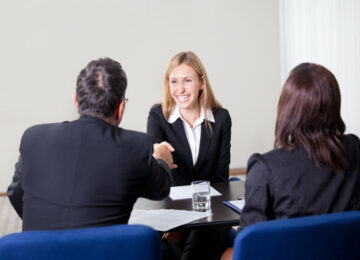 happy woman at table with others