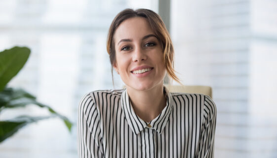 Smiling businesswoman looking at camera webcam make conference business call
