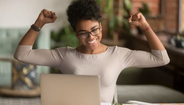 Excited african woman feeling winner rejoicing online win on laptop