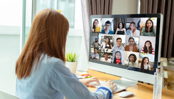 Rear view asian group business people working remotely video conference calling and meeting online teamwork discuss consulting from home on laptop computer screen home office.