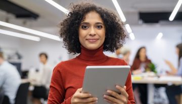 Mixed race young woman using digital tablet