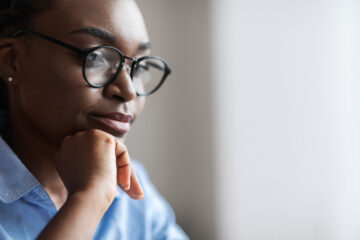 Closeup Indoor Portrait Of Black Female Business Analyst In Eyeglasses, Side View