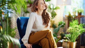smiling elegant woman with long wavy hair at home in sunny day