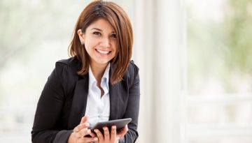 Happy businesswoman with a tablet