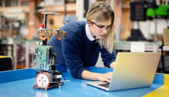 Young woman engineer working on robotics project