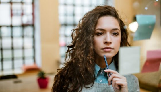 Concentrated woman making plan on sticky notes.