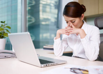 stressed asian woman head in hands