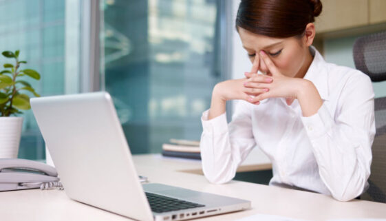 stressed asian woman head in hands